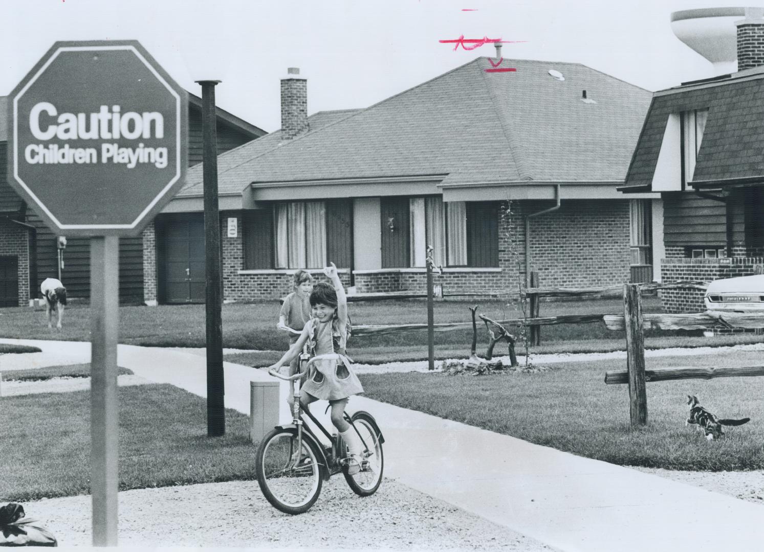 Kirwan twins, Stephen and Laurie, 6, cycle in safety in Meadowvale, to the relief of their parents, Dough and Mary Kirwan, who moved their family from(...)