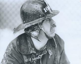 The face and moustache of North York fireman Bill Reed coated with ice today as he fought a two-alarm fire at Shower Door Co. of Canada Ltd. in the Ke(...)