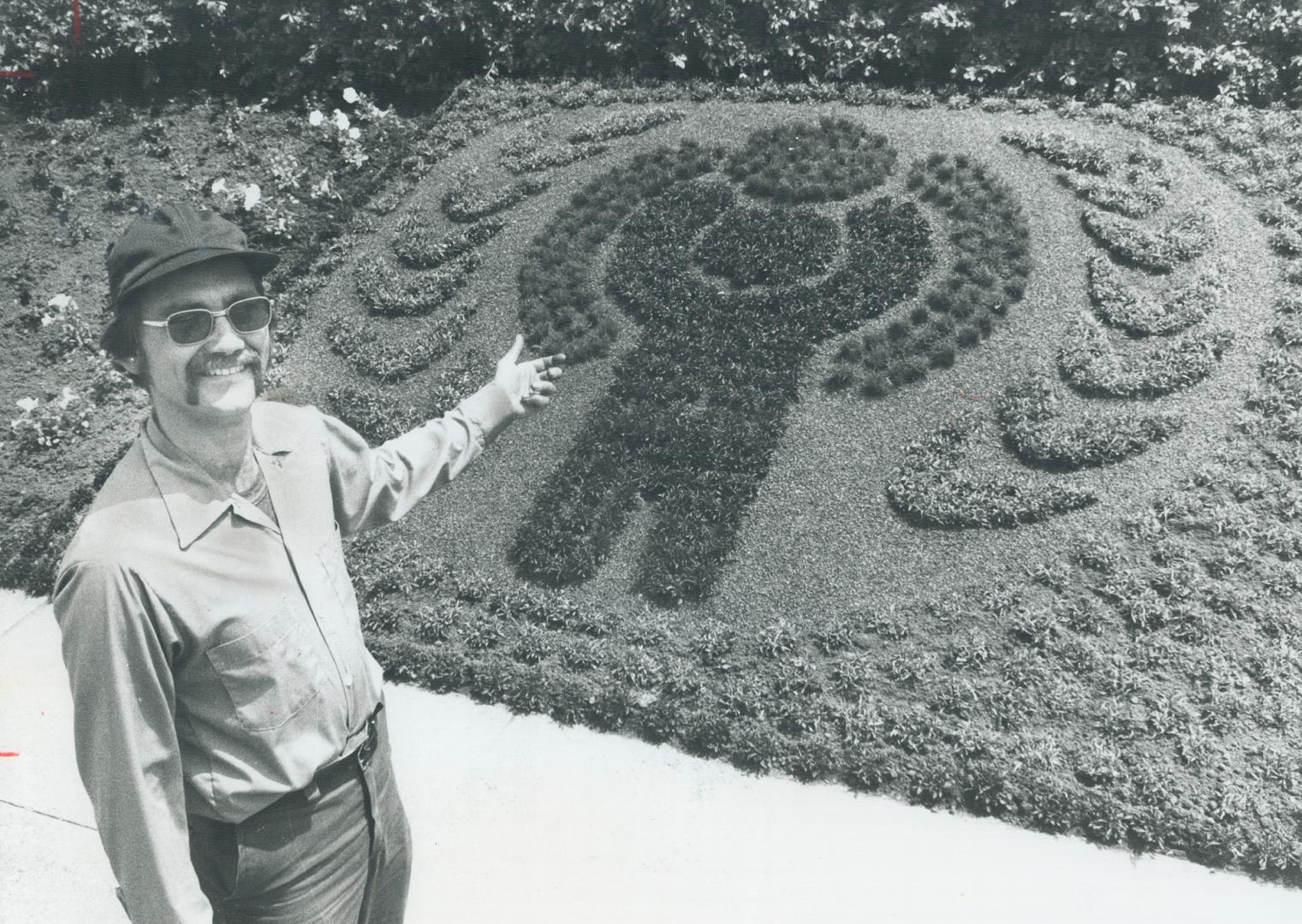 Flower child, Gardener Ingo Stahlman shows off the Internatinal Year of the Child logo rendered in flowers in the bed in front of Mississauga's City H(...)
