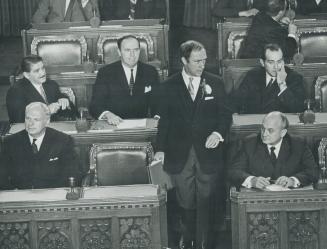 Taking Prime Minister's seat for the first time since becoming government leader, Prime Minister Pierre Trudeau, wearing salmon-colored carnation, wal(...)
