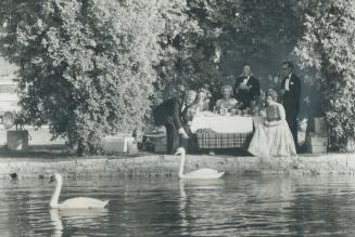 Even the swans know their roles as they swim down the Avon past a group of elegantly-dressed picknickers from Hamilton