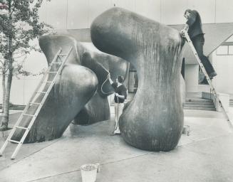 Two young technicians from sculptor Henry Moore's studio in England, Malcolm Woodward and Michael Muller, yesterday started cleaning Moore's Large Two(...)