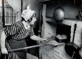 Grange cook Ruth Keene checks hearth-baked bread, Guests at buffet or luncheon will enter The Grange off Beverley St