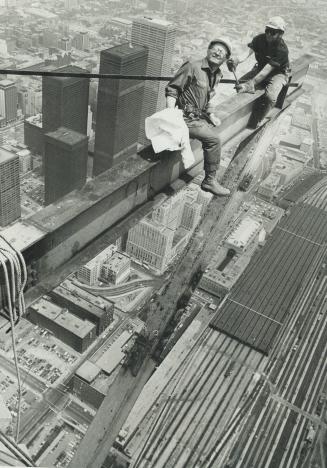 Boris Spremo. Workmen erecting the steel base for the new Top of Toronto restaurant at the Sky Pod level last year grinned back at photographer Spremo(...)