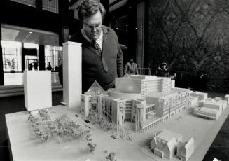 Future ballet-opera home. Bruce Hutchinson, communications officer with the Ballet Opera House Corp. examines a display model of the new ballet opera (...)