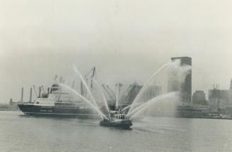 An 8-hose salute greets new freighter, With eight hoses spraying water high in the air, a Toronto fireboat gives a welcoming salute in Toronto Harbor today to a new lake freighter