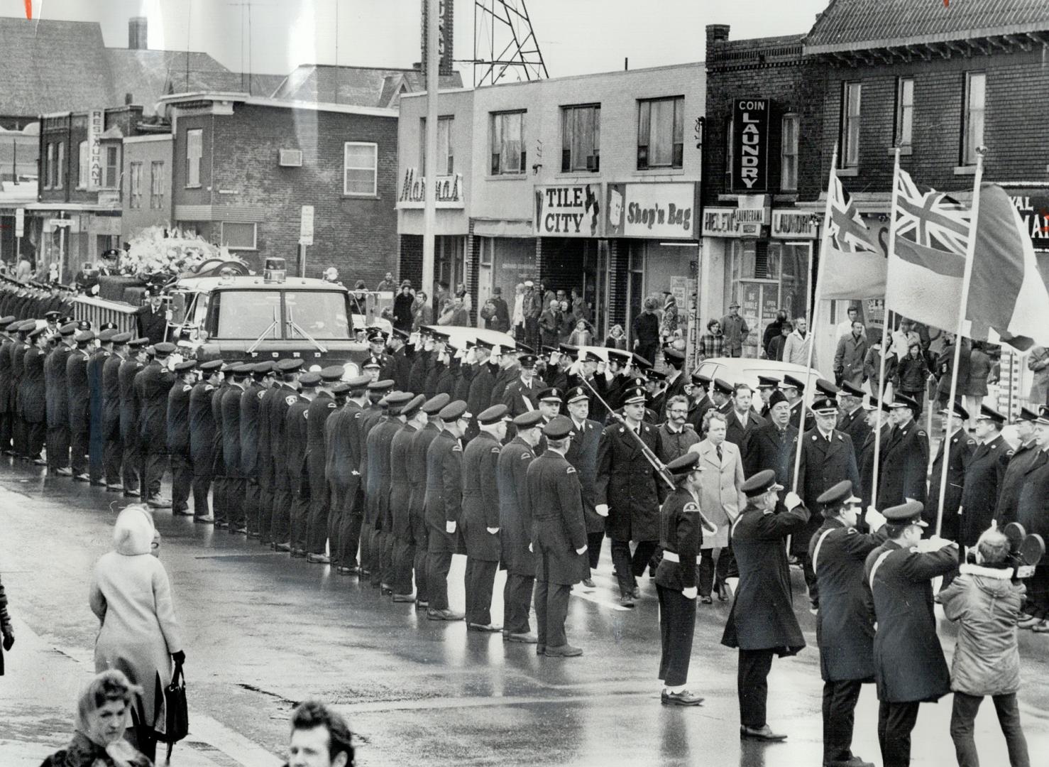 Firemen pay last respects to one of their own, Draped in the Canadian flag and banked with flowers, the coffin of Toronto Fire Capt. Jack Leslie Armst(...)