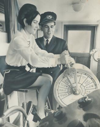 Image shows a captain and the bride inside the ship cabin.