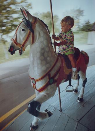 Wonder Ride: Jesse Boyle, 3, enjoys Centre island's carousel - one of only 200 of its kind left in the world