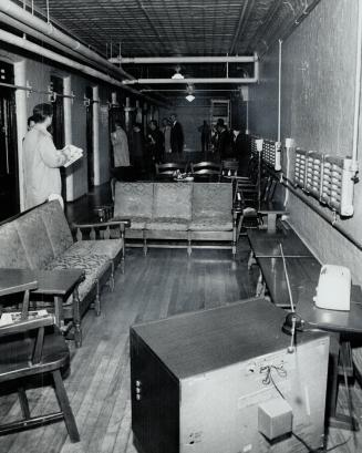 Dentention cells in the basement of Mercer Reformatory are toured by government officials and members of the press