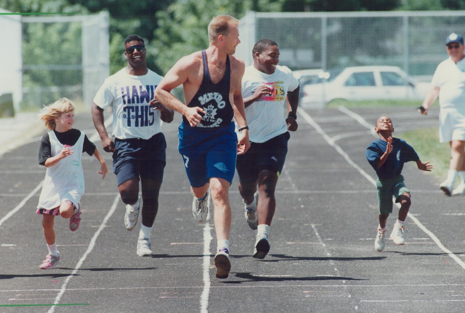 Seven-year-old Jabarl Weekes-Ambrose doesn't seem fazed by his burly competitors in the 50-metre dash during yesterday's Metro Police Games at Monarch Park Collegiate