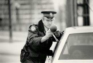 It's a sight to make a motorist's blood run cold as Constable Greg Brind alms a radar gun to check the speed of traffic