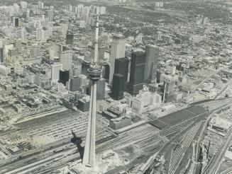 Image shows an aerial view of the CN Tower and Toronto buildings.