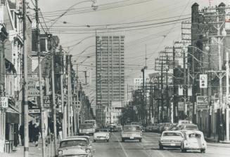 Wire maze to disapper. This is the view on Queen St. looking east from Bellwoods Park toward Yonge St. almost two miles distant. The jungle of hydro p(...)