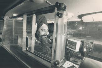 Safety first: Darshan Singh Khalsa feels safe in taxi equipped with a controversial plastic barrier for protection