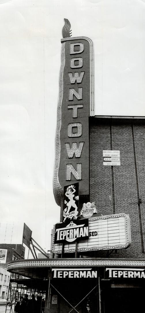 Marquee sign affixed to building reads, Downtown; smaller sign further down reads, Stripping -- ...