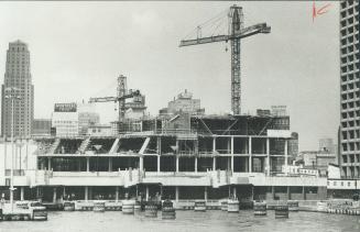 Image shows waterfront residential buildings under construction.