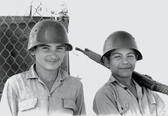 Two young boys take a spell of guard duty outside their schools Posters throughout Cuba exhort young Cubans to emulate Che. Many are eager to join guerrillas in other Latin American countries