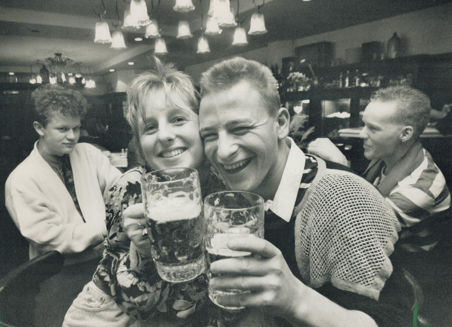 Together again: Irena Bricki, left, of West Berlin and friend Marion Deuster of East Berlin celebrate reunion in an East Berlin bar