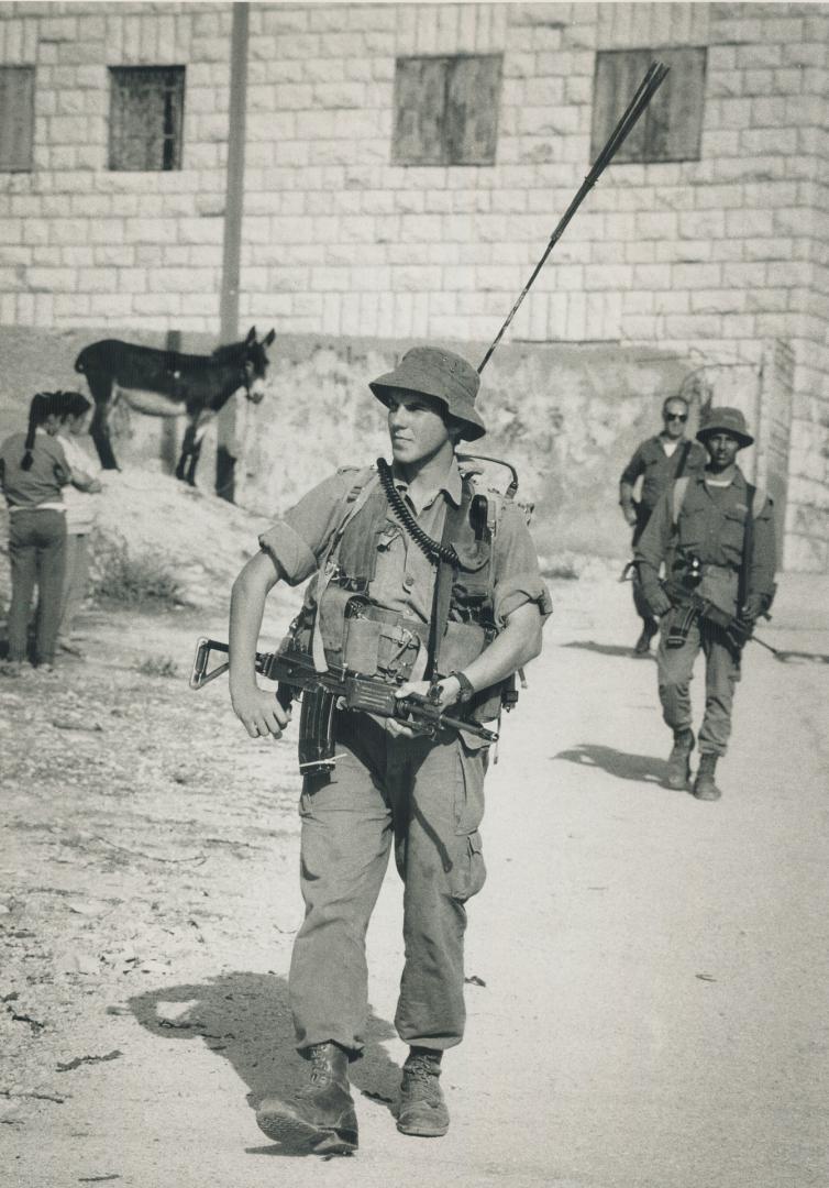 On guard: An Israeli soldier patrols in the village of Al-Houl, about 30 kilometers (19 miles south of Jerusalem