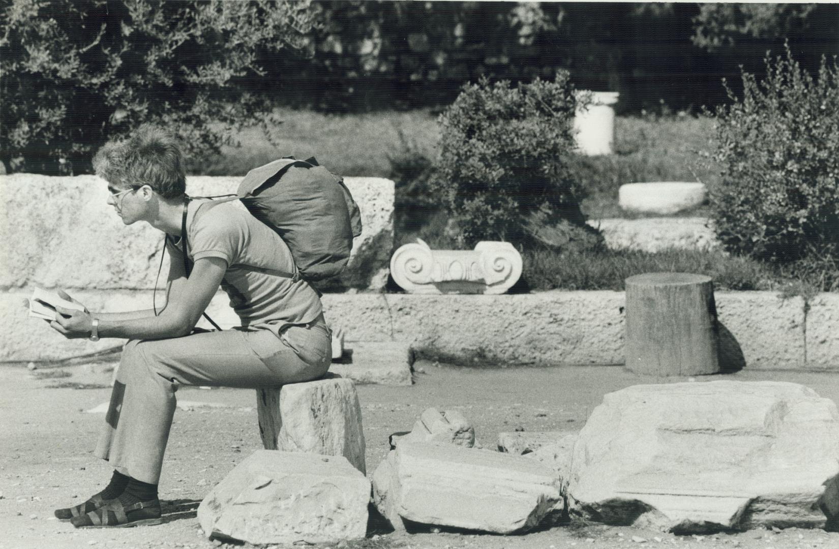 Among the ruins: Backpacker sits near temple of Zeus in Athens