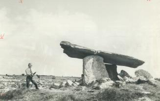 A portal dolman or megalithic tomb dating back some 5,000 years before the birth of Christ dominates a field of stone and the strange, lunar-like land(...)