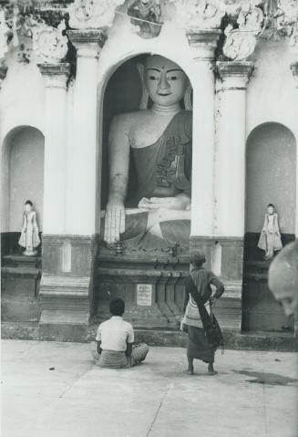One of many Buddha figures at the base of Shwedagon Pagoda