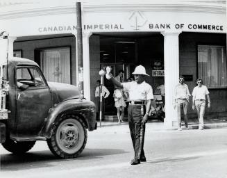 Cities such as Kingston, where the policeman, above, is a model of tropical efficiency