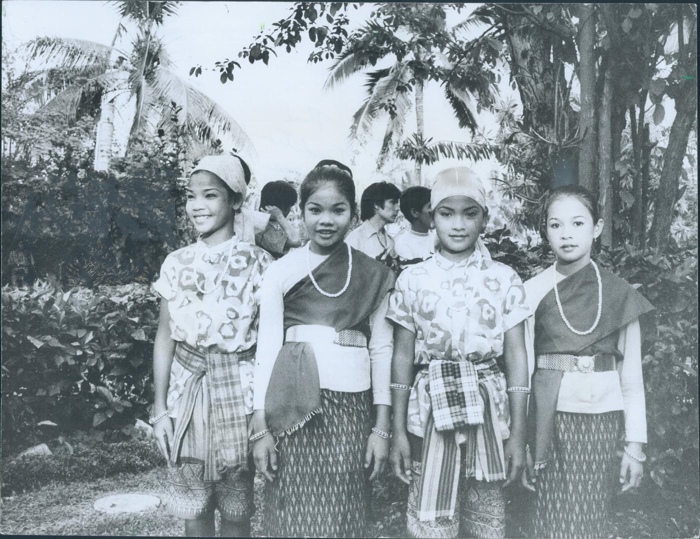 Pretty young Thai women, dancers near Bangkok, wear traditional clothes, which you can purchase for a song
