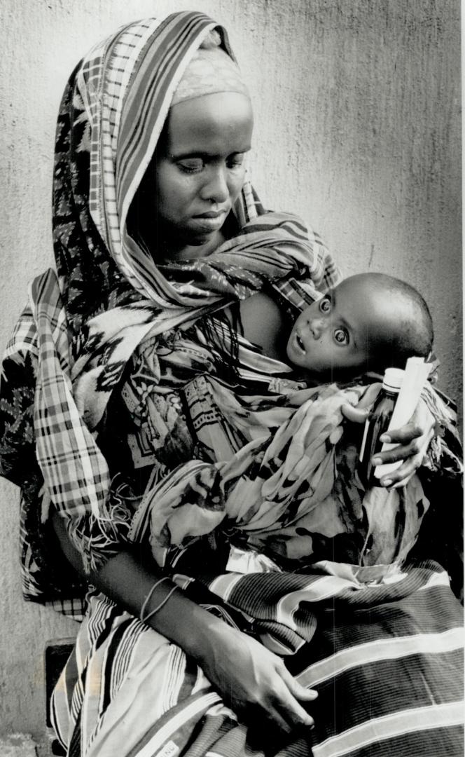 Youngest victim: A Somali woman tries to comfort her starving child amid the horror of the civil war