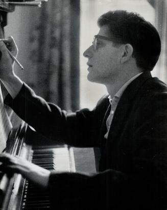 Conductor Milton Barnes works on a score
