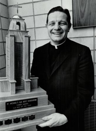 Father David Bauer with St. Mike's 'old boys of 1965' award