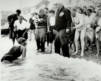 Aug. 1955 Marilyn Bell crawls ashore after swimming the English Channell