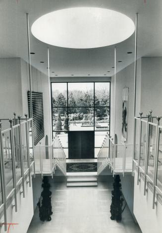 Entrance hall of Berman home is impressive and contemporary in gleaming marble