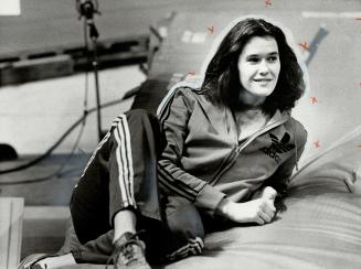 while high jump winner Debbie Brill relaxes
