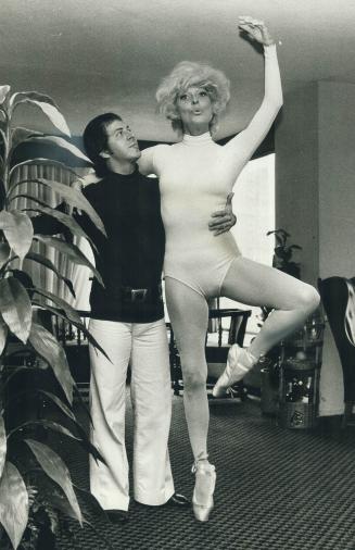 Dick Colacino helps her with ballet practice