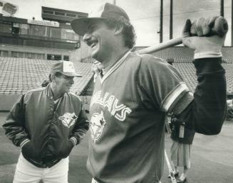 Bobby Cox and pitcher Jim Clancy share a laugh as Clancy prepares to take batting practice