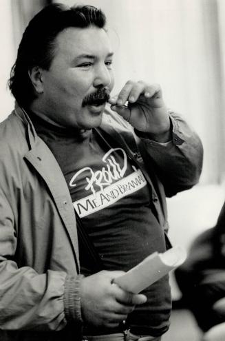 Big man in boxing: Former heavyweight champion George Chuvalo looks as if he could give the scales a tussle himself as he observes the weighing in ceremonies