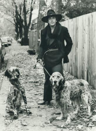 Walking his setters near his Cabbagetown home, Toller Cranston wears dramatic black and gray