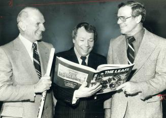 Toronto Mayor David Crombie looks over book commemorating ch anniversary of Maple Leaf hockey team