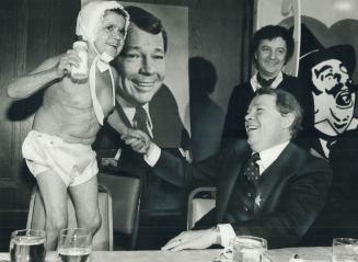 Tiny Plea. A midget in a diaper pleading with Health Minister David Crombie not to chop the baby bonus was one of the highlights of the roast of Toron(...)