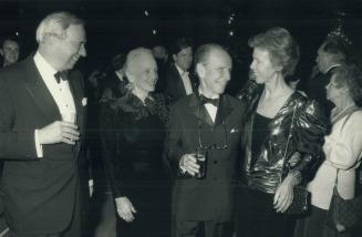 Far left to right, Darcy McKeough, Ridley College class of '51, chats with special guests Jessica Tandy, in a black velvet sheath, Hume Cronyn, class of 1930, and Joyce McKeough in a gold lame top