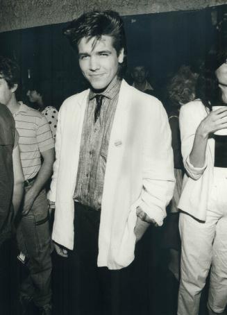Soap star Michael Damian wears white bold-shouldered blazer, striped linen shirt, pants from Japan and black leather tie