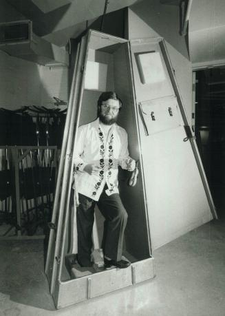 Peek-a-boo: Andrew Davis, Toronto Symphony conductor, tests the inside of double-bass carrier in preparation for the longest tour ever undertaken by a Canadian orchestra