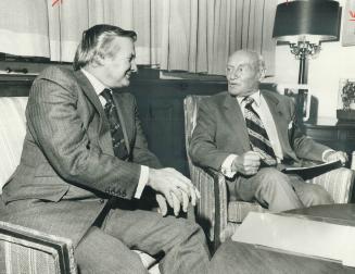Joining the effort, Premier William Davis chats with Conn Smythe after presenting a $1