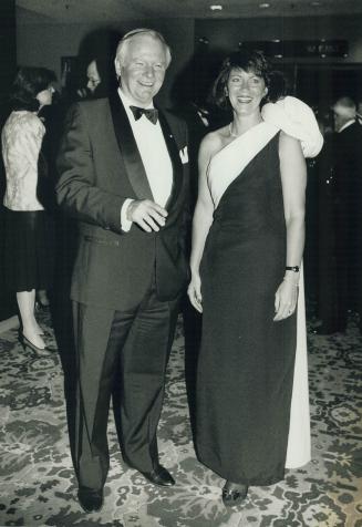 Below, Bill Davis, former premier of Ontario, chats with flight attendant Jackie Novak, in a one-shouldered gown by Julie Duroche