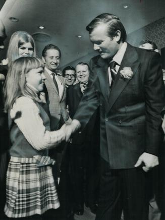 Premier William Davis shakes hands with Julie Harkness, 11, who had her autograph book signed by Davis last night at a Niagara Falls hotel, where he m(...)