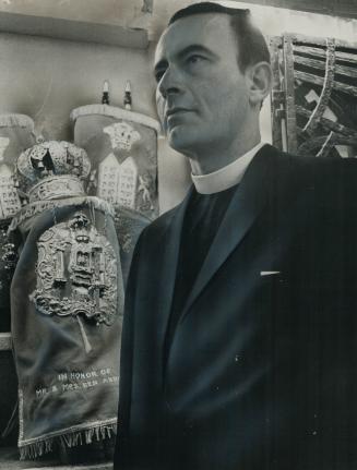 Rev. Roland De Corneille standing in Synagogue. Metro's Christian-Jewish dialogue is a model for similar programs elsewhere