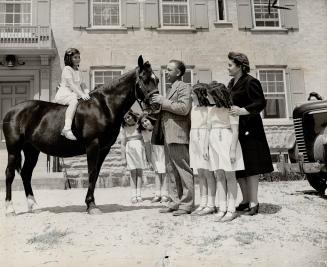 Tenth birthday gift for the Dionne quintuplets was this pony presented to them by their father