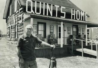 Stan Guignard stands outside former home of Dionne quintuplets that he bought and turneed into a museum
